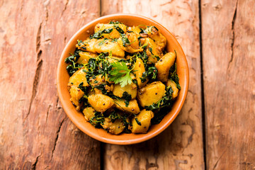 Fenugreek potato sabzi or Aloo Methi masala is healthy Indian Cuisine. served in a bowl or karahi. selective focus