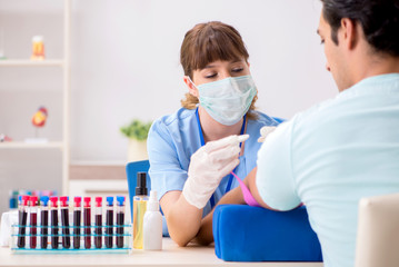 Young patient during blood test sampling procedure  