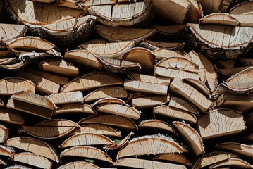 birch wood piled in a woodpile. Natural wooden background