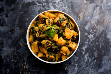 Fenugreek potato sabzi or Aloo Methi masala is healthy Indian Cuisine. served in a bowl or karahi. selective focus
