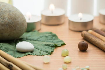 Fototapeta na wymiar Spa concept, composition with bamboo, stones, leaves and candles