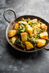 Aloo Palak sabzi - Potato cooked with spinach with added spices. a healthy Indian main course recipe. Served in a bowl, selective focus
