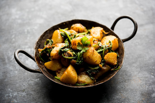 Aloo Palak sabzi - Potato cooked with spinach with added spices. a healthy Indian main course recipe. Served in a bowl, selective focus
