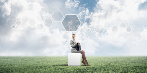 Attractive business lady or accountant outdoors on white box
