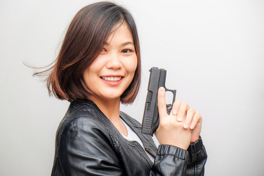Smart beautiful women holding semi automatic gun piston
