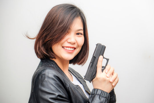 Smart beautiful women holding semi automatic gun piston