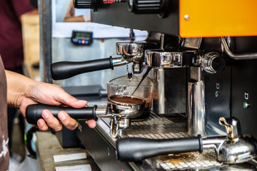 Coffee pouring machine close up in modern cafe