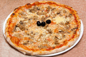 Vegetarian Pizza - Mushrooms,Melted Cheese,Black Olives,Tomato Sauce On The Plate Close Up