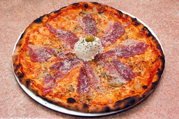 Fresh Baked Pizza With Prosciutto On The Plate Close Up