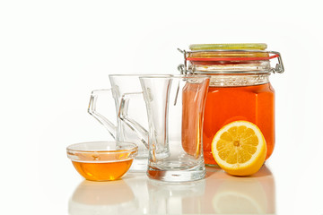 green tea with lemon and honey on white background