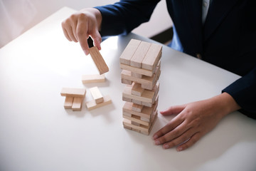Planning risk and strategy in businessman gambling placing wooden block.Business concept for growth...