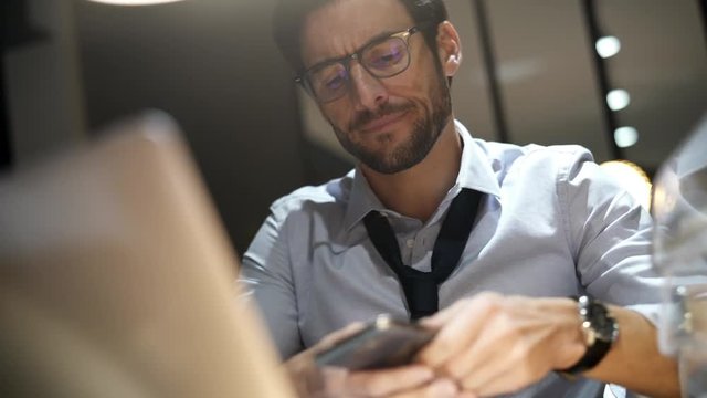 Handsome businessman working late at night in modern office