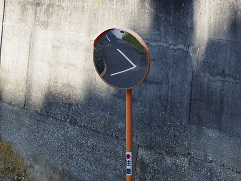 convex traffic mirror at a road curve