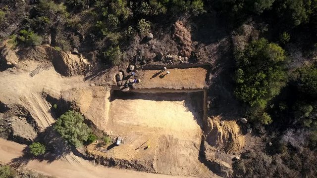 aerial view of a surveyor working on the foundations of a house