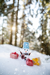 snowman and christmas tree on snow background