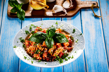 Pasta with vegetables on wooden background