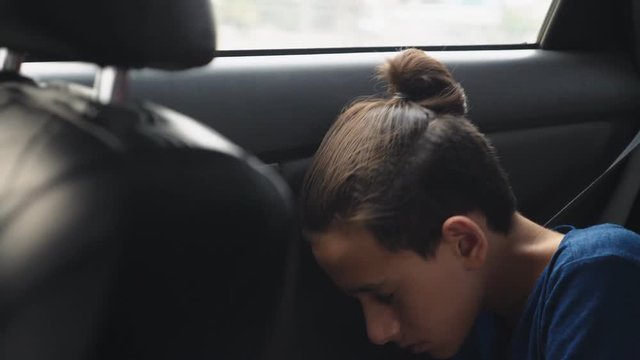 Close. Teenage Boy Sleeping In The Back Seat Of Car