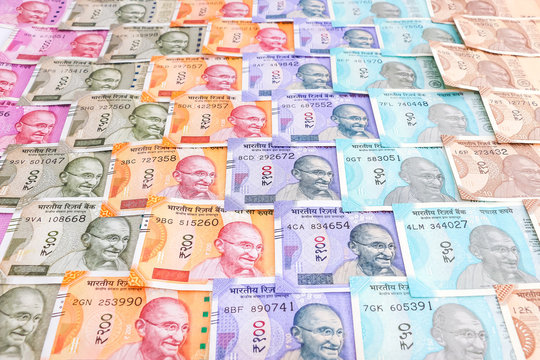 Close up view of brand new indian 10, 50, 100, 200, 500 and 2000 rupees banknotes. Colorful cash money pattern background.