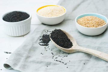 sesame seed variations on creased canvas, white wood background