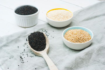 sesame seed variations on creased canvas, white wood background