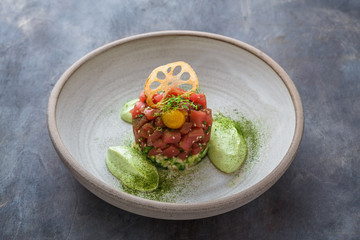 Fresh tuna tartar with lime, avocado sauce and yolk, restaurant dish