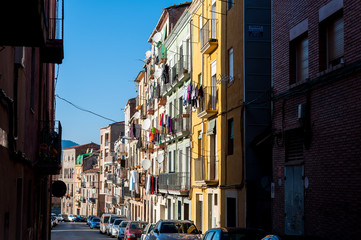 Fototapeta na wymiar view of street with colorful houses in small catalan spanish medieval town during sunny spring day and clear blue sky