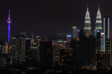 Obraz na płótnie Canvas KUALA LUMPUR, MALAYSIA - 31st DEC 2018; Night view of downtown Kuala Lumpur, a capital of Malaysia. Its modern skyline is dominated by the 451m-tall Petronas Twin Towers. 