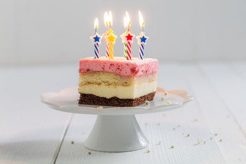 Naklejka na ściany i meble Yummy birthday cake with strawberry and burning candles