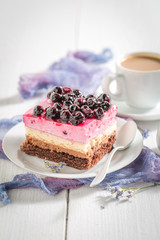 Delicious cake with black currant on white table