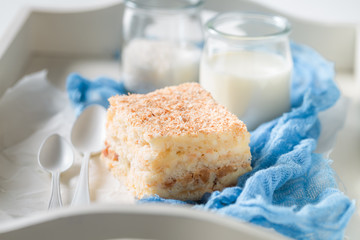 Closeup of homemade coconut cake with nuts and foam