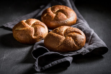 Closeup of tasty golden buns on dark grey concrete