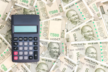 Close up view of calculator on new indian 500 rupees banknotes background.