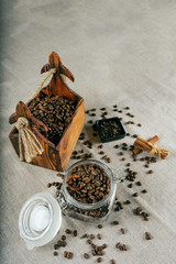 Coffee beans in a container, cinnamon, nutmeg and cloves.