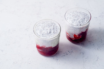 Two glasses of chia pudding with strawberry smoothie