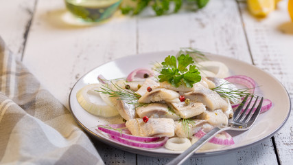 Plate of herring with oil and onion, greek style food.