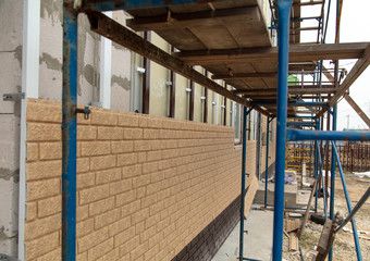 Installing siding on the walls of the house