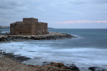 Fototapeta na wymiar Beautiful landscape with Mediterranean Sea bay in Pafos, Cyprus, medieval fortified castle on shore, horizon, long exposure