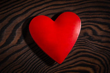Valentine's day red heart on wooden table.