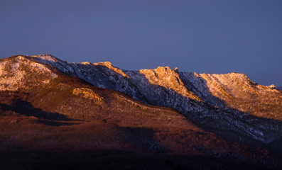 mountain range illuminated by the rising sun