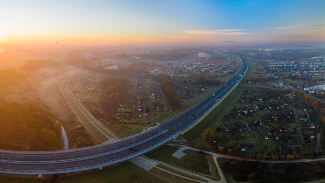 Cityscape with highway and stadion in Wroclaw during sunrise.