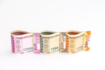 Close up view of brand new indian 200, 500 and 2000 rupees banknotes on white background.