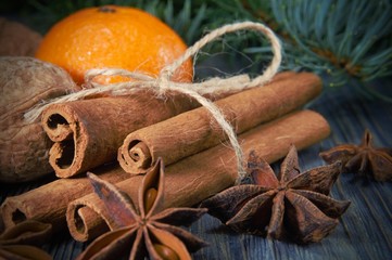 Bunch of cinnamon orange anise next to pine branch