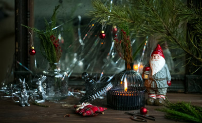 christmas background with burning candle and new year toys on wooden table