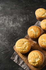 Homemade tasty miffins on black background, close up