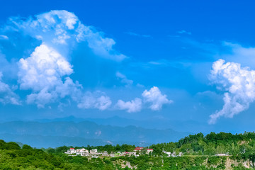 Fototapeta na wymiar Scenic view of landscape againt blue cloudy sky