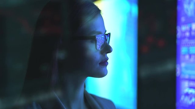 The businesswoman standing near the screen