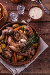Rabbit with potatoes and carrots baked in a ceramic pot