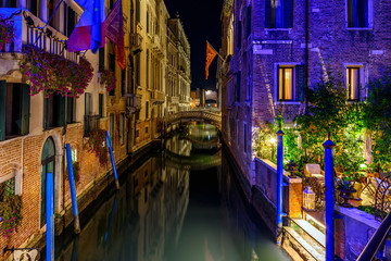 Narrow canal in Venice, Italy. Architecture and landmark of Venice. Cozy night cityscape of Venice.