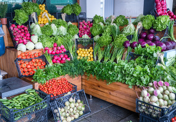 Closer looking at green vegetables at greengrocer.