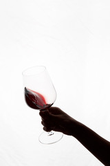 hand holding a glass of red wine